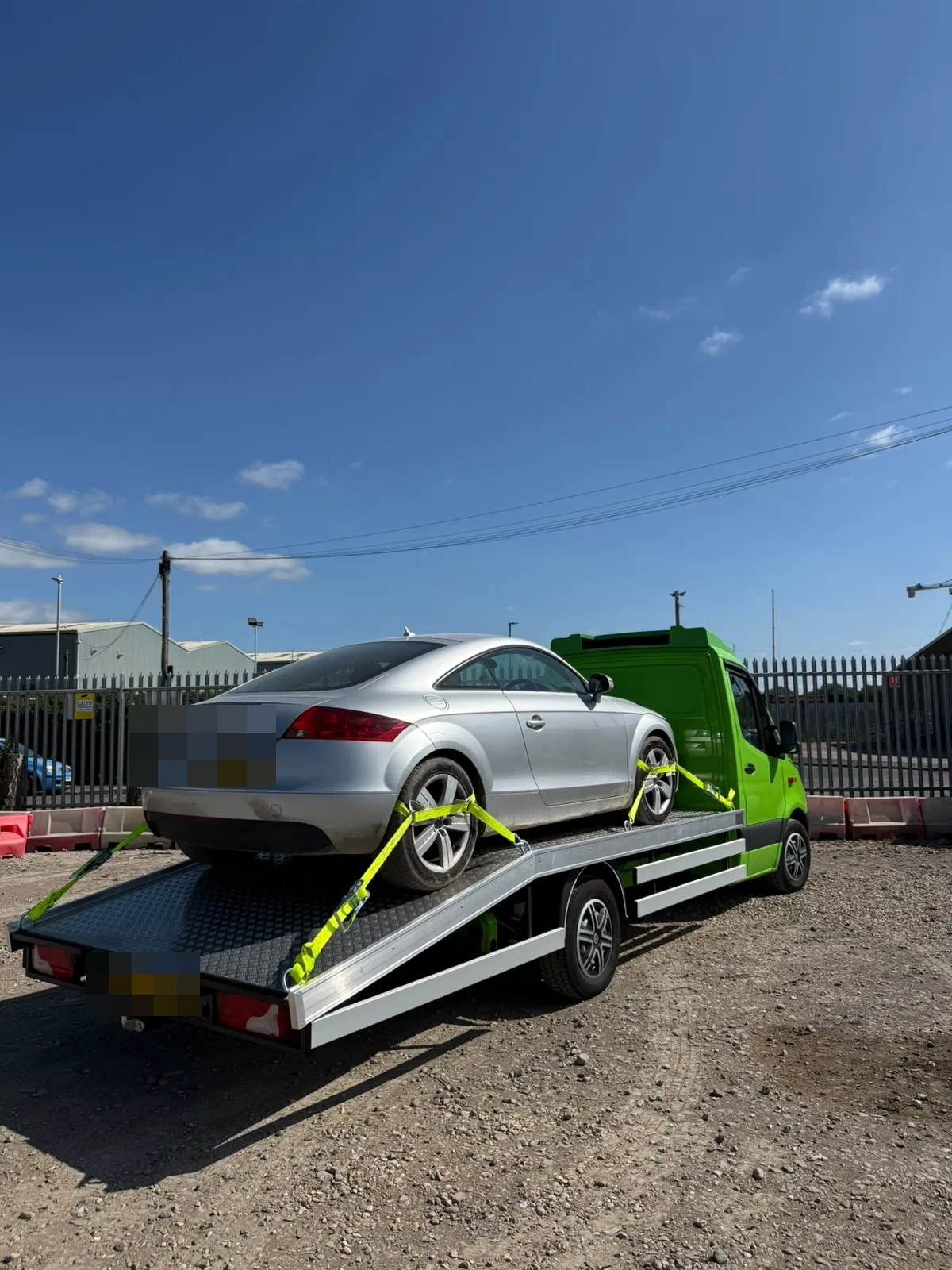 Silver Audi TT on the flatbed in a yard